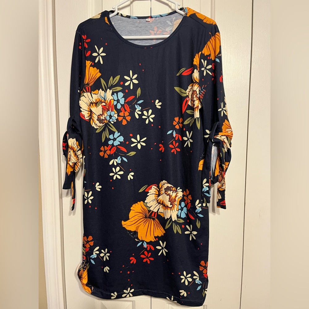 Large floral dress with tie up sleeves. Stretchy fabric.